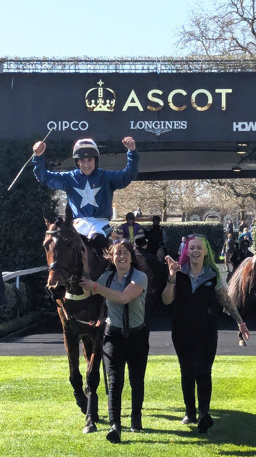 Benvoy's jockey punches the air at Ascot while the Jo Davis Racing team celebrate beside him