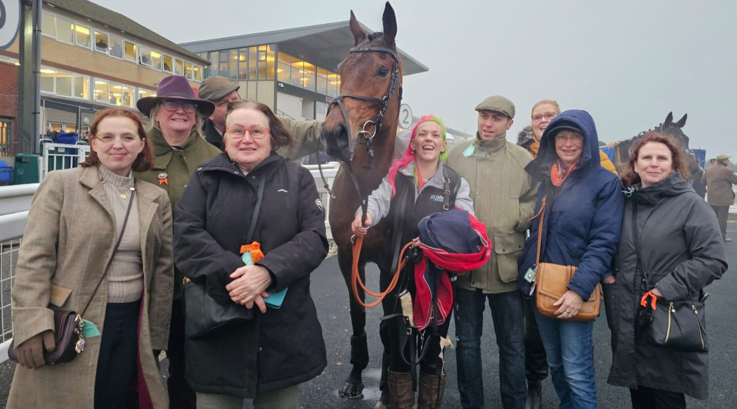 Syndicate members and yard staff gathered around Jaja Jimmy at the races
