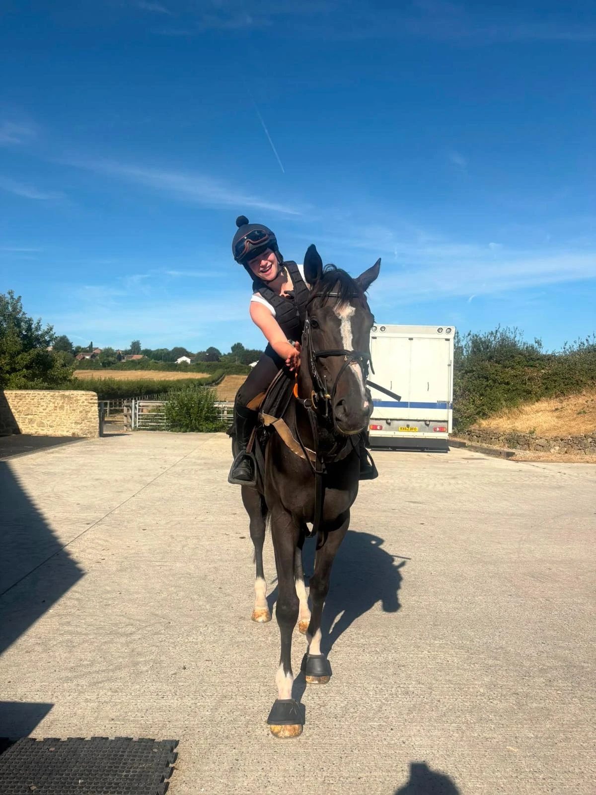 Fleur on a dark bay horse in the yard